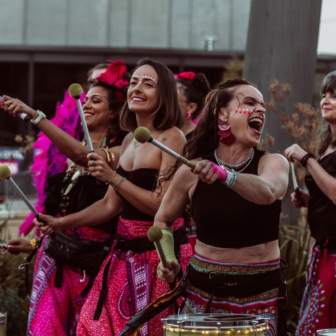 Banda Ziriguidum drummers mid-performance in their pink carnival costumes